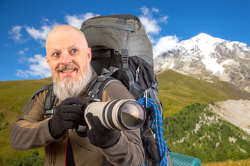 Fototapeta premium bearded man tourist photographer with a backpack photographs the beauty of nature in the mountains. nature hikes in the mountains