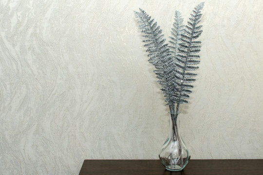 Decorative silver fern in a glass vase