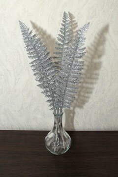 Decorative silver fern in a glass vase