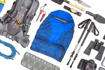 Set of tourist trekking items on white background. Top view of accessories for travel. Equipment...