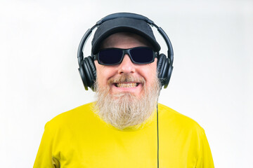 Fototapeta premium bearded man in sunglasses and headphones listens to music. audio sound style and technology