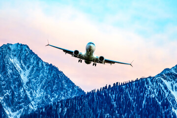 passenger plane flies over the mountains. air transport industry
