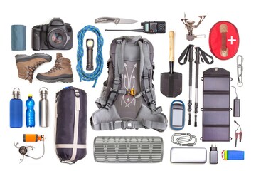 Set of tourist trekking items on white background. Top view of accessories for travel. Equipment for travel and hiking. Survival Items.