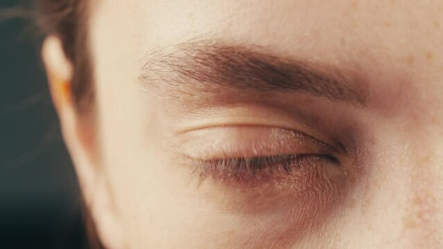 Nervous tic. Obsessive-compulsive disorders. Patient of a psychiatric clinic. Woman biting lips, scratch face, biting nails, eye twitching. Close up, macro. 