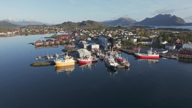 Aerial Islands scenery with traditional fishing boats lying in harbor on sunny day with scenic blue sky, Norway, Scandinavia, northern Europe