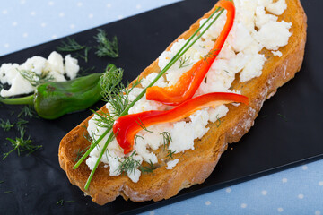 Delicious sandwich in Bulgarian-style with brynza, bell pepper and greens