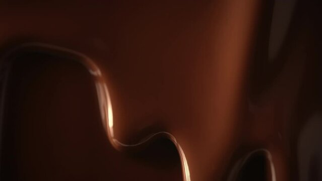 Close-up macro shot seamless dripping hot melted liquid chocolate flows, flowing molten chocolate or dark caramel sauce stream background. Chocolate drip. Confectionery. Pouring chocolate waves