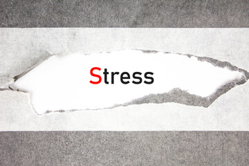 Stress word, acronym on torn paper. STRESS concept.