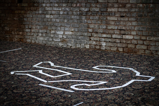 A white tape chalk outline in the shape of a dead body.