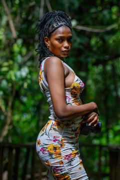 A portrait of a young african tourist walking in the forest glades