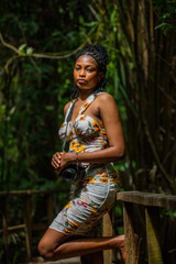 A portrait of a young african tourist walking in the forest glades