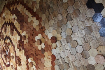 Amazing 3D pattern mosaic hexagon wood wall art floor background with teak wood, walnut, and pinewood material texture grain Close up