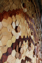 Amazing 3D pattern mosaic hexagon wood wall art floor background with teak wood, walnut, and pinewood material texture grain Close up