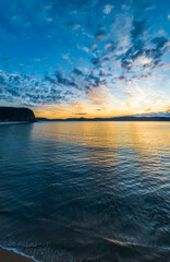 Fototapeta premium Aerial sunrise seascape with pretty cloud filled sky