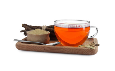Aromatic licorice tea in cup, dried sticks of licorice root, powder and spoon on white background