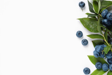 Tasty fresh blueberries with green leaves on white background, flat lay. Space for text