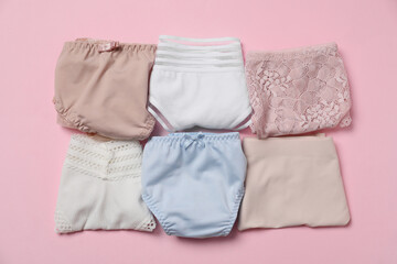 Stylish folded women's underwear on pink background, flat lay