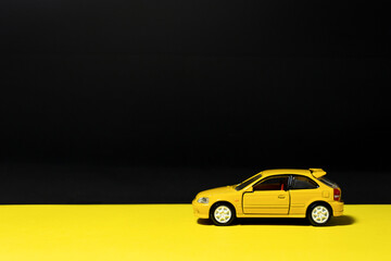 Fototapeta na wymiar Yellow toy car isolated on multicolored background. After some edits.