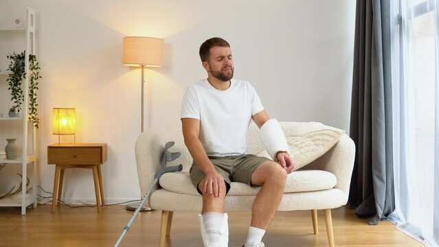 A man with crutch suffer pain from a broken leg