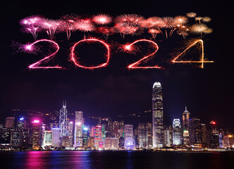 2024 Happy New Year fireworks over Hong Kong cityscape at night.