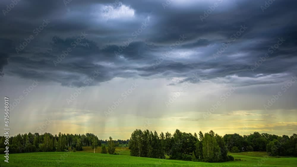 Poster it is captivating to observe rain clouds gracefully gliding over a valley of lush green fields from 