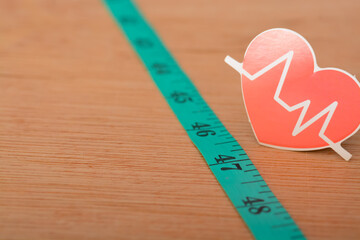 Heartbeat rate symbol and measuring tape. keeping track of your heart rate provides you with...
