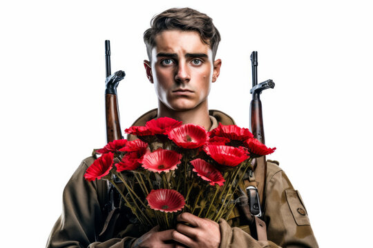 Portrait of a military soldier holding a bunch of red poppy flowers, the symbol of remembrance