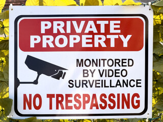 Plaque on the fence. Caption: Private property. No trespassing - obrazy, fototapety, plakaty