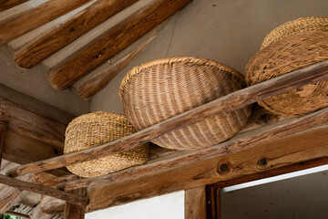 A round, rimmed woven basket made of finely-split bamboo. Sokuri - obrazy, fototapety, plakaty