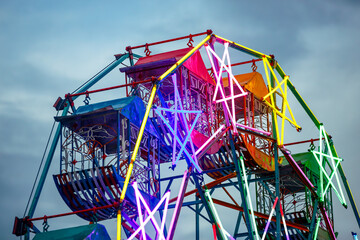 moving Ferris wheel in blue twilight evening