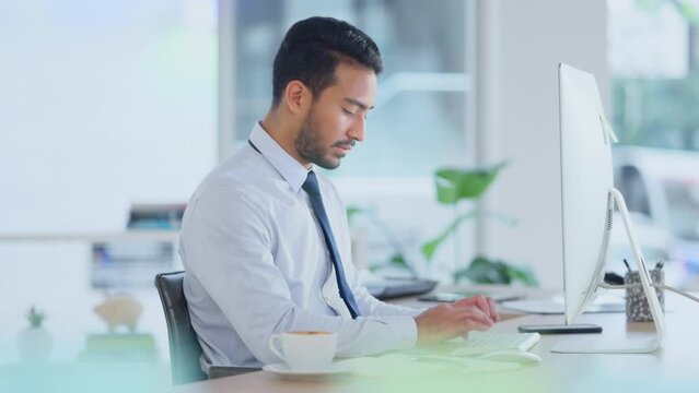 Busy male Accountant typing an email in a modern office. A financial advisor compiling a finance proposal for a successful company. A serious Auditor writing a business investment report
