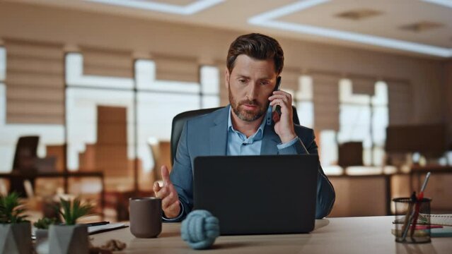 Man banker calling client nervous conversation in office closeup. Ceo arguing