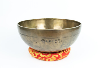 Tibetan handcrafted full moon singing bowl with Om Mani Padme Hum mantra crafted isolated on white background