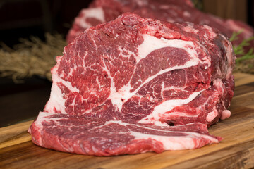 Close-up beef raw red steak on wooden board background.Meat texture.