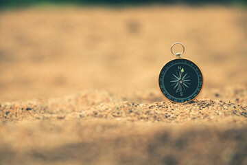 Travel of tourists with compass. compass of tourists on sandy beach.