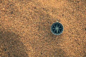 Travel of tourists with compass. compass of tourists on sandy beach.