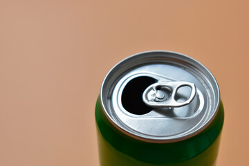 aluminum green drink cans on orange background, open cold fresh beverage