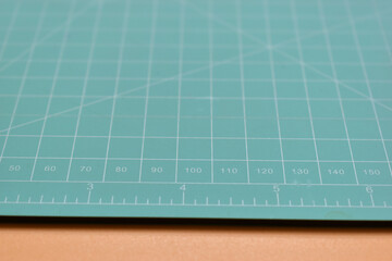 green cutting mat on orange background, object tool for design