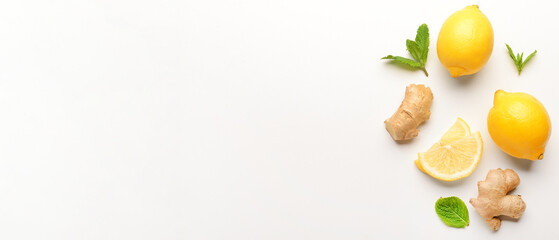 Fresh lemons, ginger and mint on white background with space for text