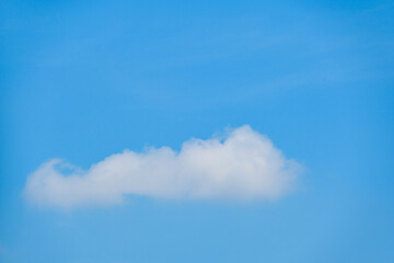 beautiful blue sky and white fluffy single cloud with sunrise in the morning, natural background