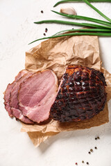 Tasty smoked ham on light background