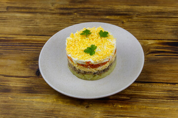 Traditional russian salad Mimosa on wooden table