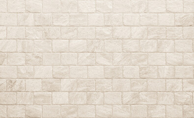 Empty background of wide cream brick wall texture. Beige old brown brick wall concrete or stone...
