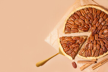 Tasty pecan pie on orange background