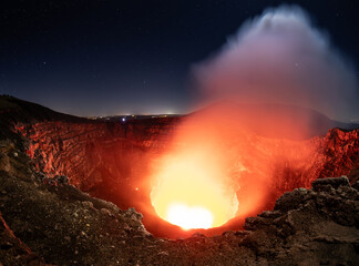 A view into the crater with bubbling lava, molten magma,  and gases of the majestic and still active Masaya volcano in Nicaragua, Central America