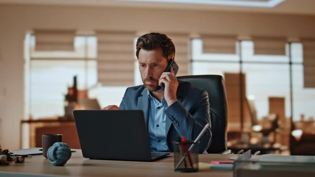 Confident businessman speaking mobile phone at cabinet closeup. Manager working