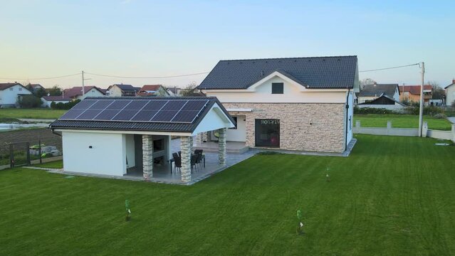 Aerial view of a suburban house, smart home powered by photovoltaic solar cells