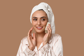 Young woman with soap on brown background, closeup