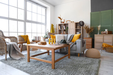 Interior of living room with grey sofa and table