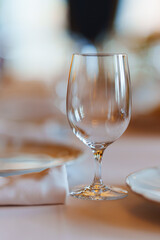 An empty wine glass on a table served for a banquet. 